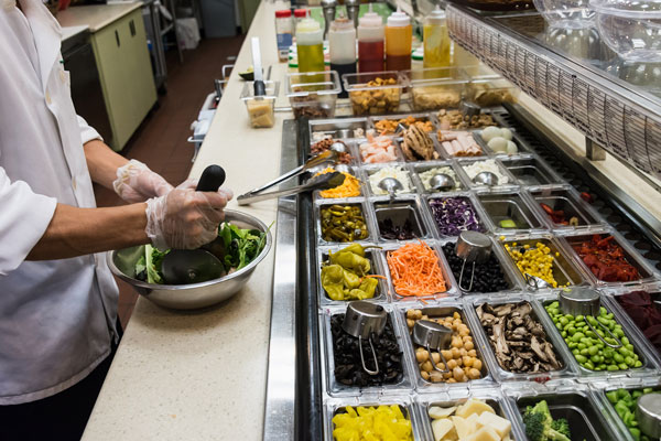 Person making a salad from healthy food